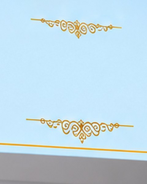 Gold filigree framing a blank name panel on a pastel blue box